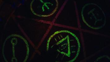 Mysterious glowing symbols on dark surface in atmospheric setting video