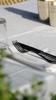 An Elegant Dining Setting Featuring Cutlery Arranged on a White Tablecloth video