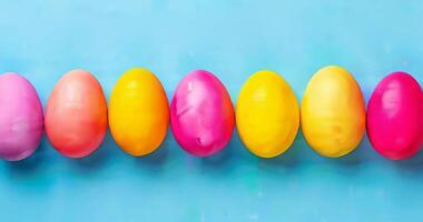 Top view of painted colorful easter eggs on blue background. Greeting card, holiday celebration and happy Easter concept. Festive background video