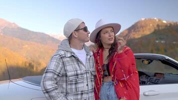 portrait of happy honeymooners travelling by car in mountains, man and woman admiring landscape video