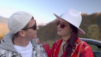 Couple in love look at each other enjoying communication in nature in mountains. video