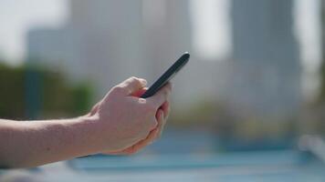 internet addiction and problematic social media use, closeup view of hands with smartphone in city video