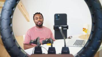 expert conducting blog in social media, streaming in live, talking to camera of smartphone video