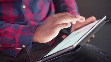 male user surfing website of internet clothes store on tablet, closeup view of gadgets in man hands video
