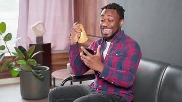 black man rejoicing by win in mobile game or goal of favorite team, portrait of smartphone user video