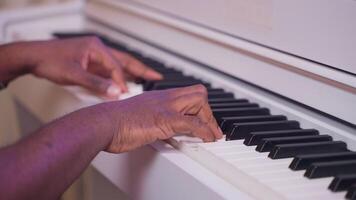composer writing new song, playing piano in studio, closeup of hands of black guy on keyboard video