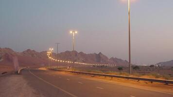 car traffic on highway in desert in evening time, empty road and wind video
