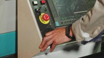 A Close Up View of the Control Panel Featuring the Operators Hand Engaged in Operation. Media video