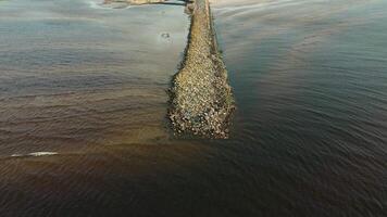 Long Stone Causeway Dividing Water with Open Fields in Background video