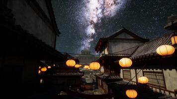 Nighttime view of traditional Japanese architecture under a starry sky video