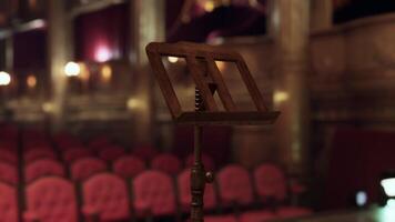 Old opera house stage with an empty music stand awaiting performance video