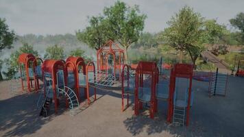 Brightly colored playground structure in a lush park setting during daylight video