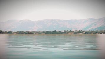 Serene lake view with mountains in the background during a calm afternoon video