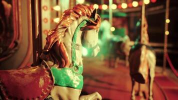 An empty amusement park at night with a deserted carousel and glowing lights video