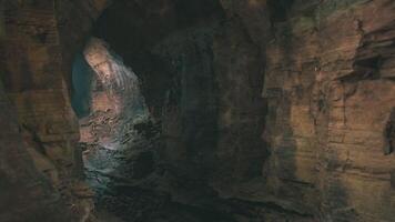 Exploring the serene beauty of a cavern with natural light streaming in video