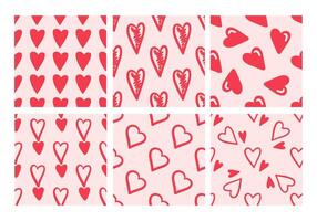 Assortment of seamless patterns with red hearts on pink background in doodle style vector