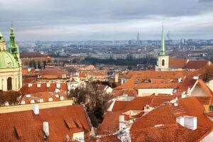 Prague rooftops panorama, winter city view, distant skyline photo