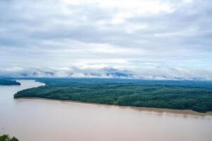 River island aerial view, misty mountains background, travel brochure photo