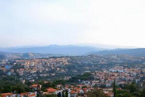 Hilltop village panoramic view, mountains background, travel photography photo