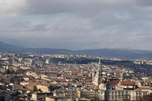 Cityscape panoramic view, mountains, cloudy sky, architecture, travel brochure photo