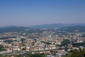 Hilltop Cityscape Panoramic view, summer day, mountains backdrop, travel brochure photo