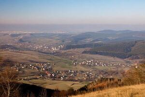 Hilltop view Valley town, hazy city skyline, autumn photo