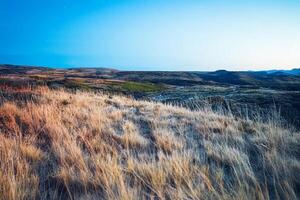 Golden Sunset Over Grassy Hills, Canyon Background photo