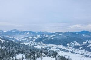 Snowy mountain range aerial view, winter landscape photo