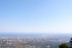 Coastal city panorama, aerial view, summer day, hazy background photo