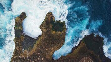 Waves crashing on the rocks, drone view with blue ocean on Lembongan island video