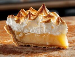 Close up of a slice of lemon meringue pie with a browned meringue topping photo