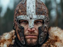 Close up portrait of a medieval warrior in rusty helmet photo