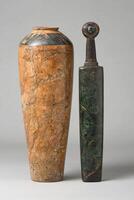 Ancient artifacts. a marble vase and a jade dagger photo