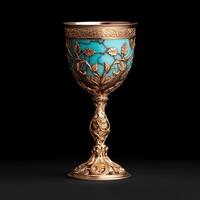 Ornate golden chalice with turquoise inlay on black background photo