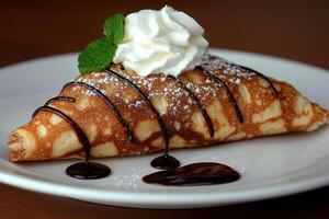 Delicious crepe with whipped cream and chocolate sauce. photo