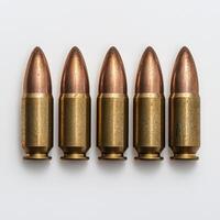 Five bullets lined up in a row on a white background photo
