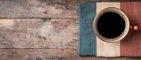 Top view of a cup of coffee on a rustic wooden table photo
