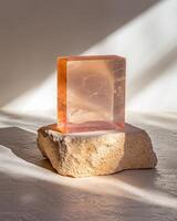 Translucent orange block on a light beige stone photo