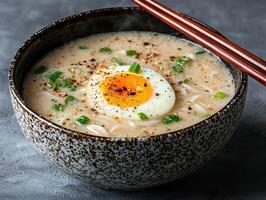 Delicious ramen noodle soup with soft boiled egg in a rustic bowl photo