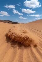 Off road vehicle kicking up sand in the desert photo
