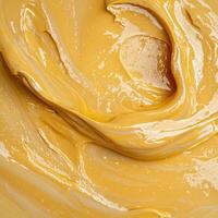 Abstract swirling golden paint texture background photo