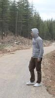 Hitchhiking on asphalt road in forest video