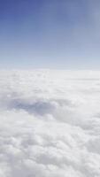 Fluffy clouds and blue sky at high altitude. Serene and tranquil aerial view, ethereal horizon, dreamy atmosphere, scenic cloudscape, peaceful environment, and minimalist beauty. video
