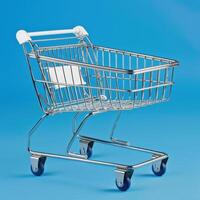 Empty metal shopping cart against a bright blue background. photo