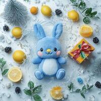 Adorable blue bunny plush surrounded by citrus fruits and festive decorations. photo
