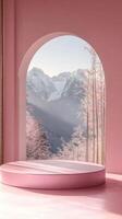 Elegant pink interior with an arched window view of snowy mountains and trees. photo