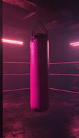 Dimly lit boxing ring with a vibrant pink punching bag illuminated by neon lights. photo