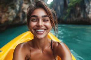 Smiling young woman kayaking on turquoise waters, surrounded by cliffs. photo