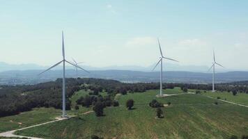 Exploring a vast wind farm with numerous turbines in a green landscape video