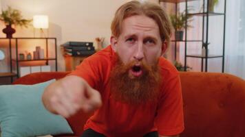 Bearded man smiling, pointing to camera, choosing lucky winner, indicating, inviting approve at home video